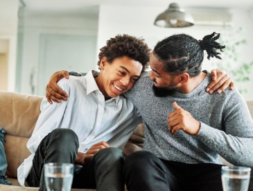 Portrait of a happy teenage boy son talking to his father at home. Sharing secrets and having fun, support and parenthood concept